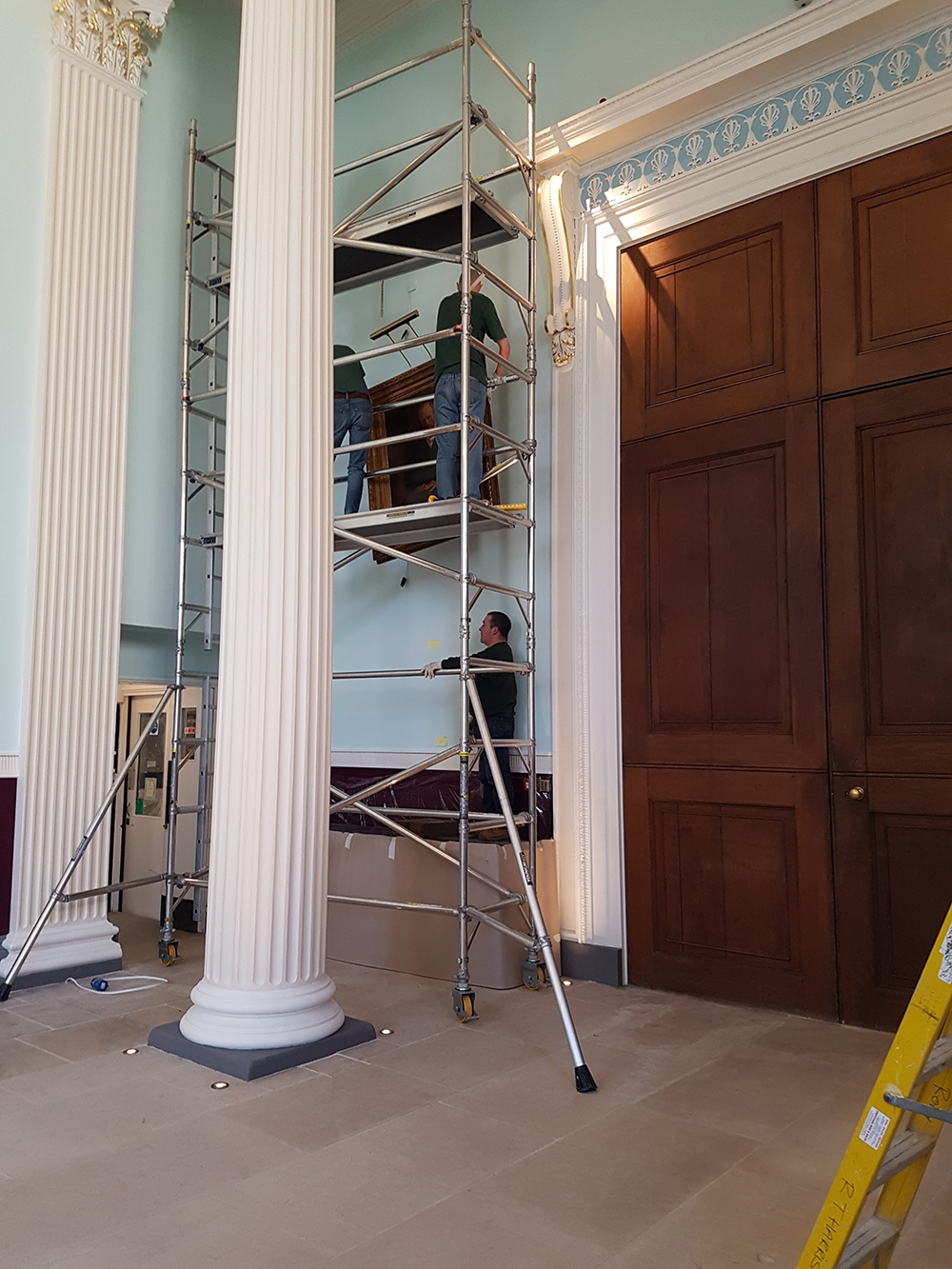 worcester college oxford paintings being hung with hogarth picture lights attached